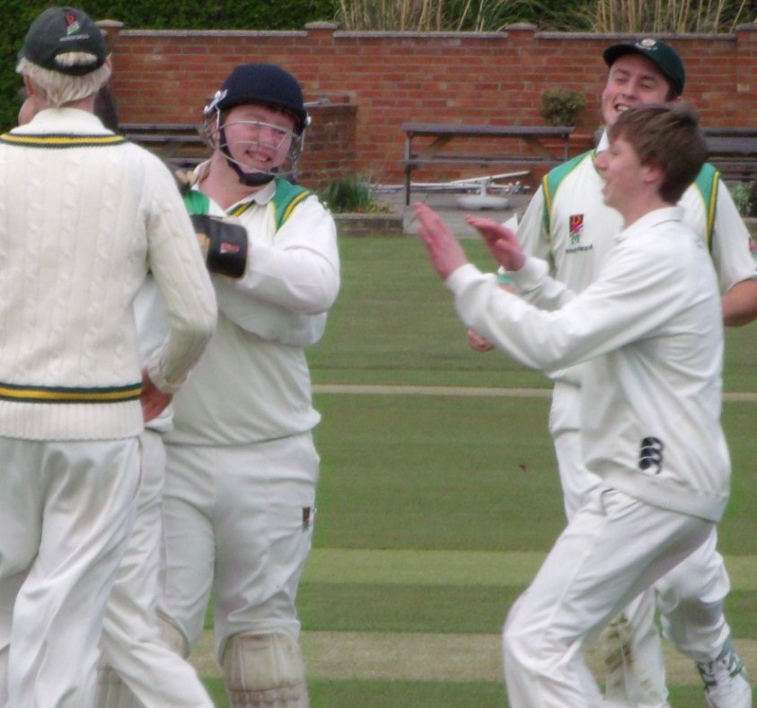 Team celebrating taking a wicket